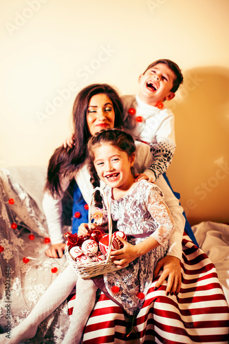cute family at Christmas, mother son and daughter together having fun, lifestyle people at holiday