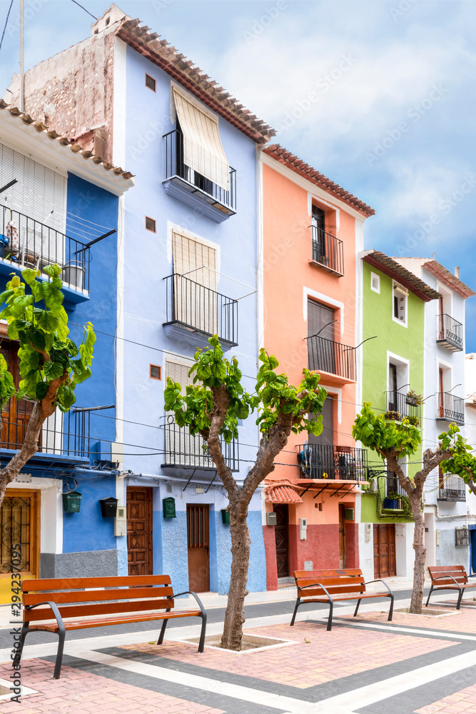 Fototapeta premium Cityscape. Mediterranean street with bright colorful houses. Villajoyosa, Spain, Apr.2019