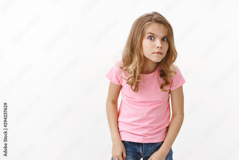 Intrigued smart, nosy and curious young little girl, peeking, frowning look strict and serious forward, hear something, stare suspicious uncertain, eavesdropping, overhear interesting conversation Intrigued smart, nosy and curious young little girl, peeking, frowning look strict and serious forward, hear something, stare suspicious uncertain, eavesdropping, overhear interesting conversation