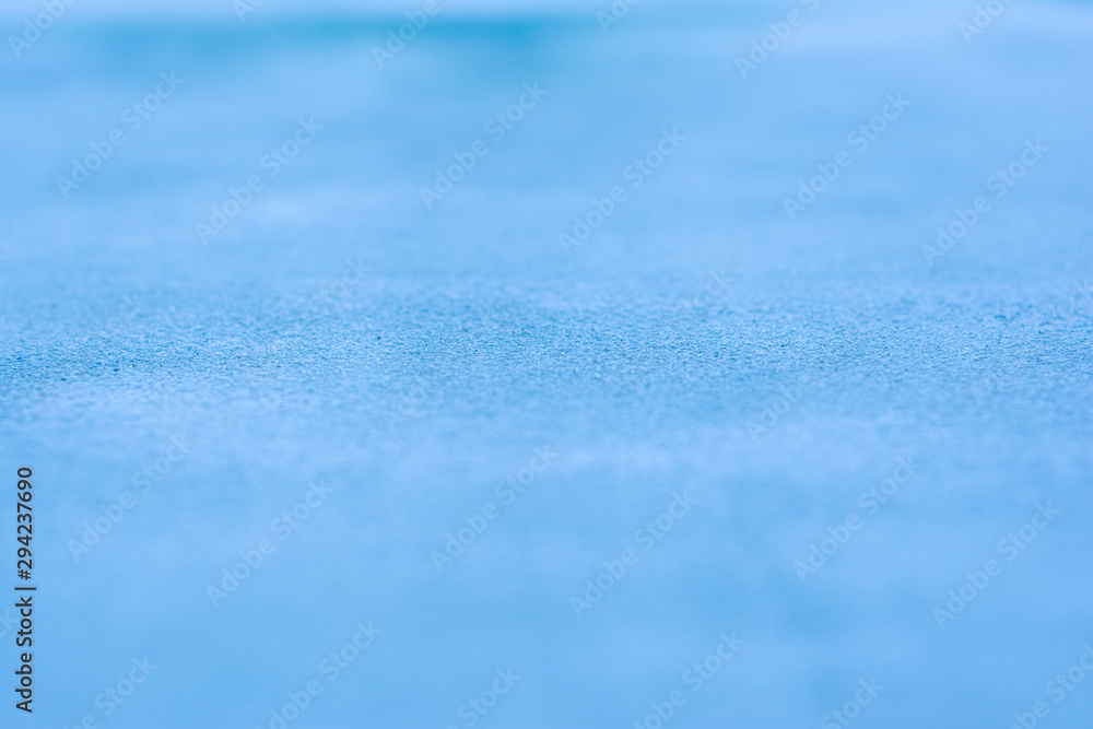 Background with a blue stone surface shot at an angle with a very small depth of field and a very blurred foreground and background Background with a blue stone surface shot at an angle with a very small depth of field and a very blurred foreground and background