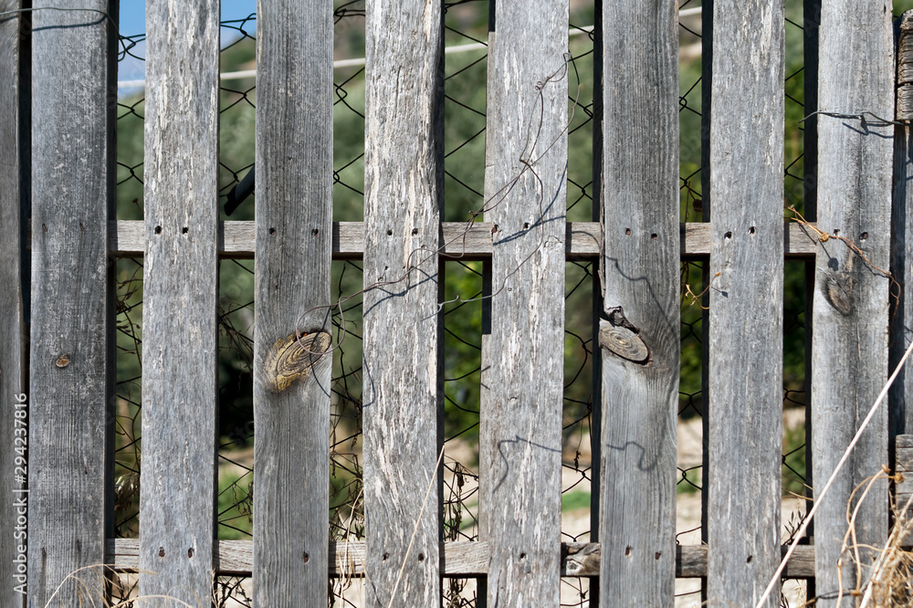 Old wooden fence in sunlight Old wooden fence in sunlight