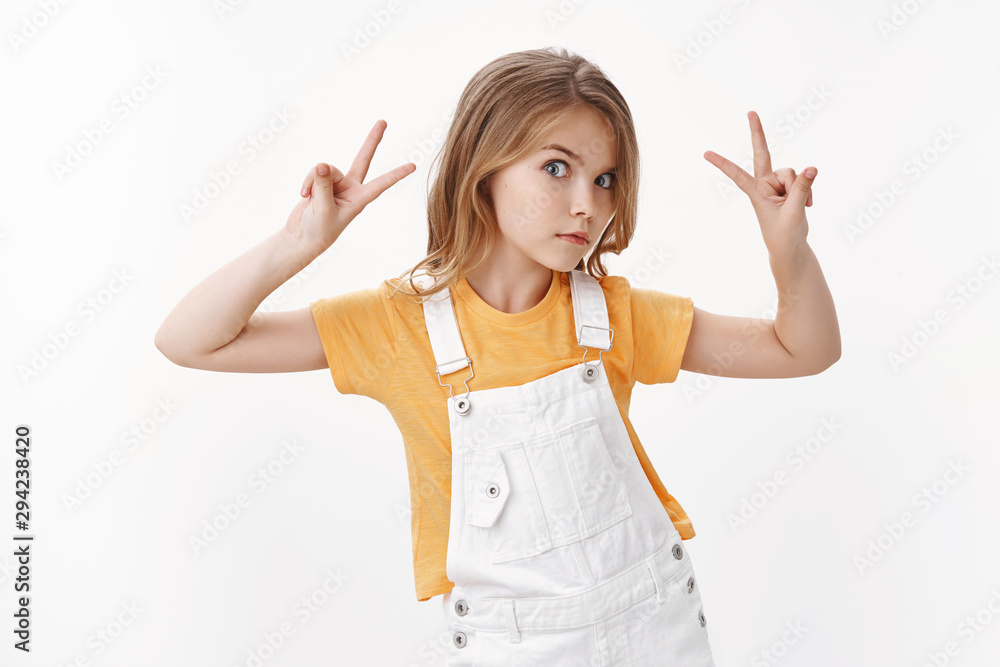 Cool stylish cute blond little girl, mimic funny expressions, peeking curious, staring camera playfully, raise hands show peace and victory signs, fool around posing summer vacation photo album Cool stylish cute blond little girl, mimic funny expressions, peeking curious, staring camera playfully, raise hands show peace and victory signs, fool around posing summer vacation photo album