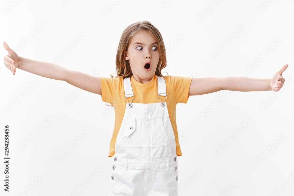 Impressed funny cute blond girl extend hands and showing something big very large and huge, explain lengths and size open mouth amazed, gasping astonished stare copy space, white background Impressed funny cute blond girl extend hands and showing something big very large and huge, explain lengths and size open mouth amazed, gasping astonished stare copy space, white background