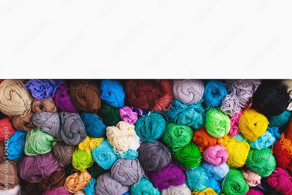 Сrocheting and knitting. Colorful multicolored skeins of yarn in the box on a white background. Women's hobby.