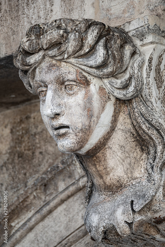 Facade ancient sculpture of beautiful Venetian woman as decoration of Doge Palace in Venice, Italy