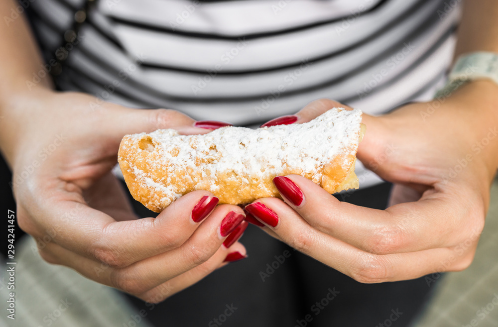 Close up of cannoli, a traditional Italian crunchy pastry with cream inside Close up of cannoli, a traditional Italian crunchy pastry with cream inside