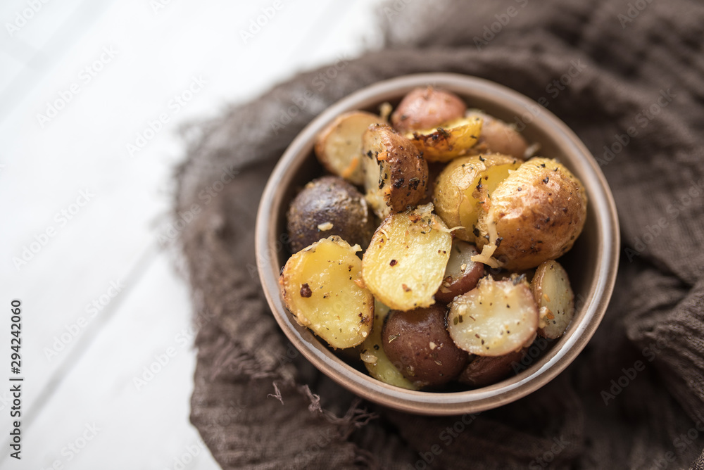 Delicious Roasted mini potato with spices and Parmesan cheese, cut in halves Delicious Roasted mini potato with spices and Parmesan cheese, cut in halves