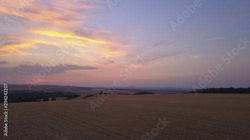 Aerial view of a Agricultural fields at sunset or sunrise in Europe. Drone shot