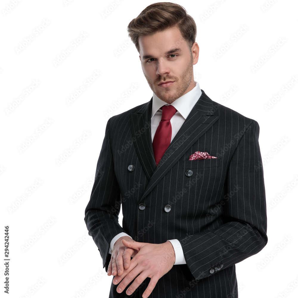 elegant young businessman wearing double breasted suit and red tie elegant young businessman wearing double breasted suit and red tie