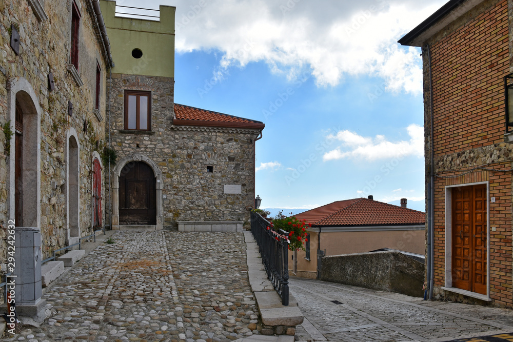 Morra de Sanctis, Italy, 09/28/2019. The road between the houses of a quiet rural village, with typically Mediterranean architecture.