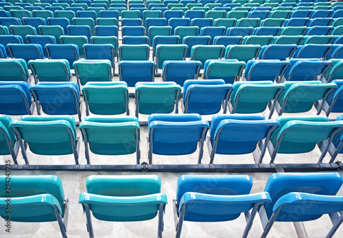 Perspective view of of folded blue chairs or seats in stadium