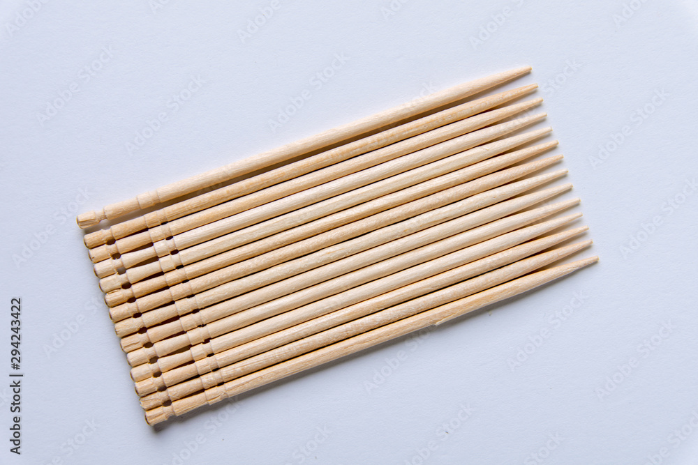 Toothpicks on a white background. From above. Text space Toothpicks on a white background. From above. Text space
