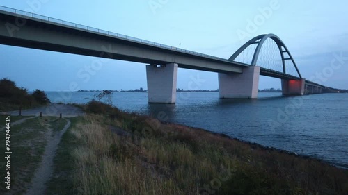 Fehmarn Sound bridge 4k video footage, camera panning from bridge to sunset left to right photo