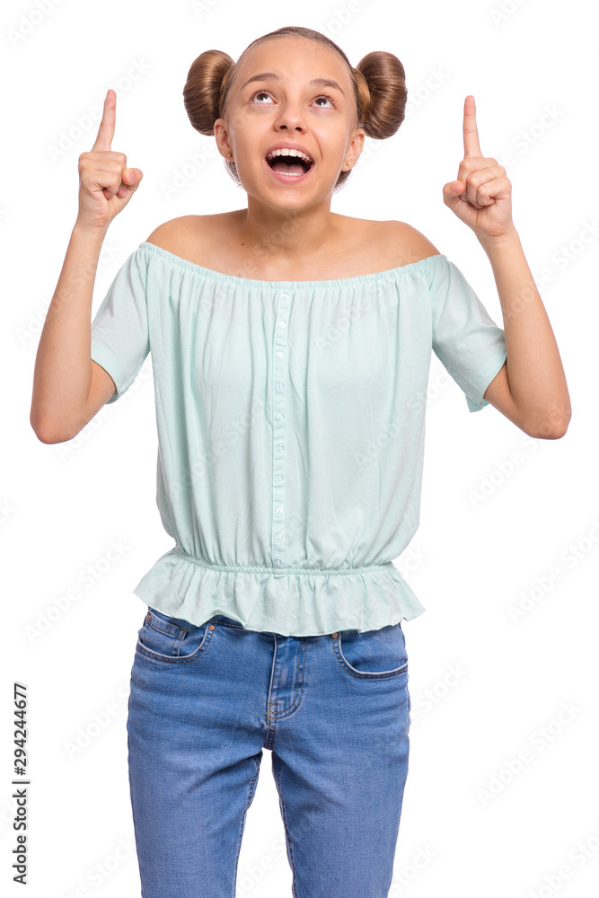 Portrait of teen girl pointing fingers up at copyspace, isolated on white background. Beautiful caucasian young teenager attracted by attention at something. Surprised or amazed child. Portrait of teen girl pointing fingers up at copyspace, isolated on white background. Beautiful caucasian young teenager attracted by attention at something. Surprised or amazed child.