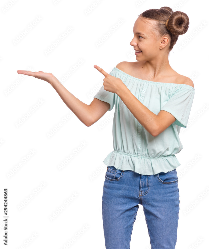 Portrait of teen girl pointing finger away at copyspace, isolated on white background. Beautiful caucasian young teenager smiling and attracted by attention pointing finger at something. Happy child. Portrait of teen girl pointing finger away at copyspace, isolated on white background. Beautiful caucasian young teenager smiling and attracted by attention pointing finger at something. Happy child.