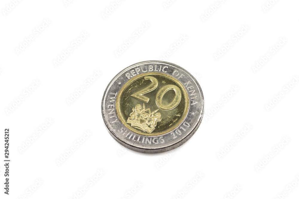 A close up, macro image of a twenty shilling coin from Kenya cutout on a white background.