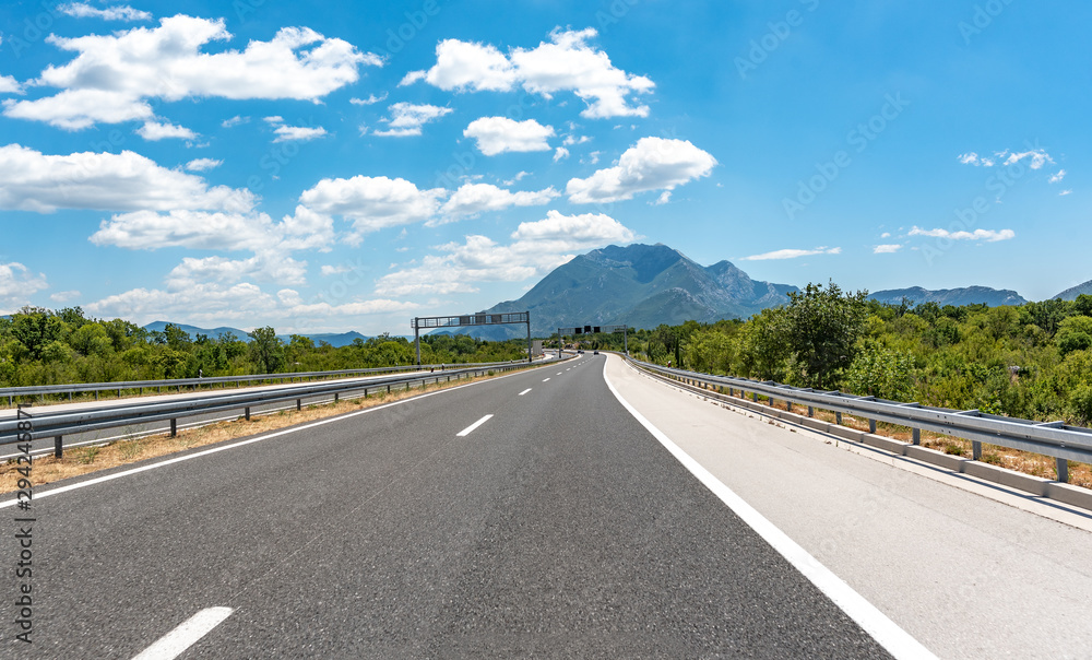High-speed highway in beautiful mountainous terrain in sunny day. High-speed highway in beautiful mountainous terrain in sunny day.