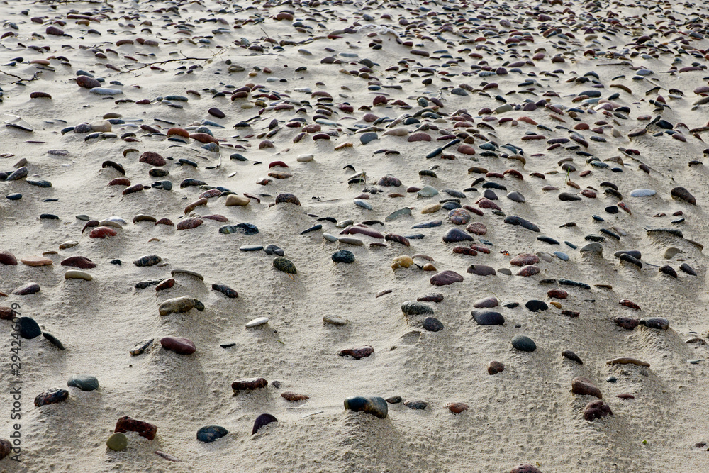 sandy beach with many small stones, beautiful background sandy beach with many small stones, beautiful background