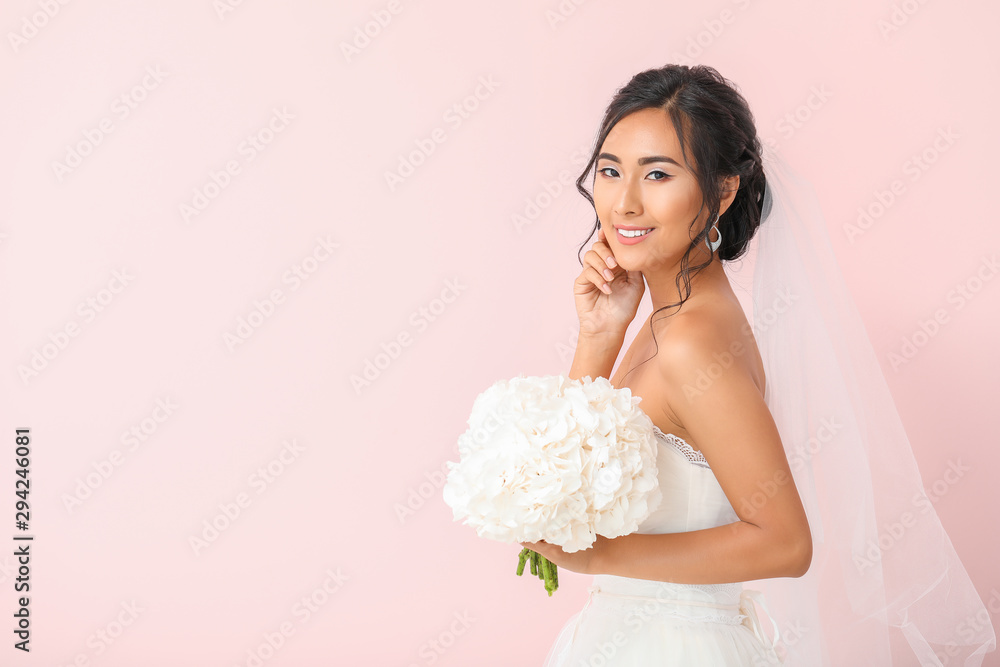 Beautiful young Asian bride on color background Beautiful young Asian bride on color background