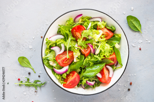 Green salad from fresh leaves and tomatoes.