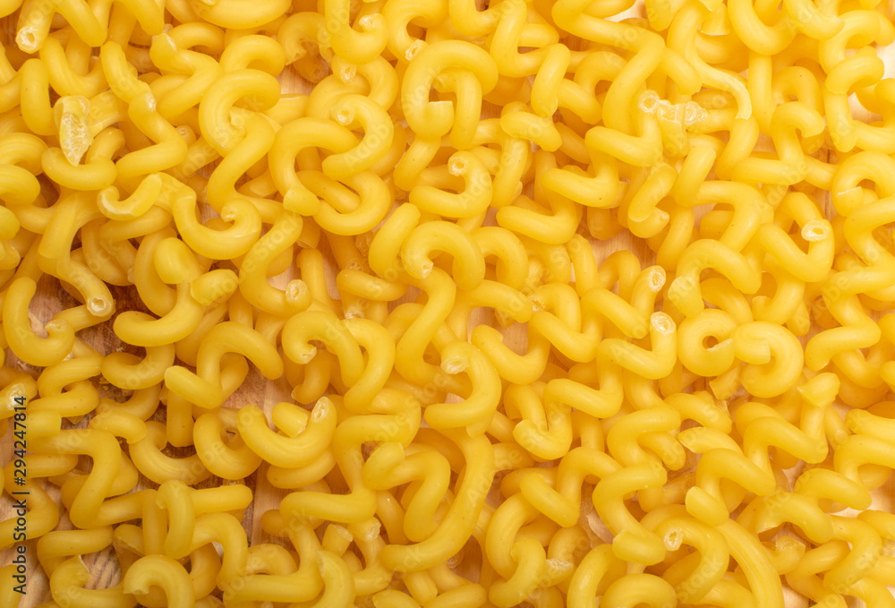 Raw yellow cavatappi pasta texture background top view Raw yellow cavatappi pasta texture background top view