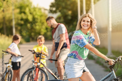 Woman and her family riding bicycles outdoors