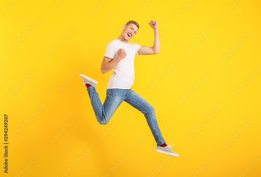 Jumping man in stylish t-shirt on color background Jumping man in stylish t-shirt on color background