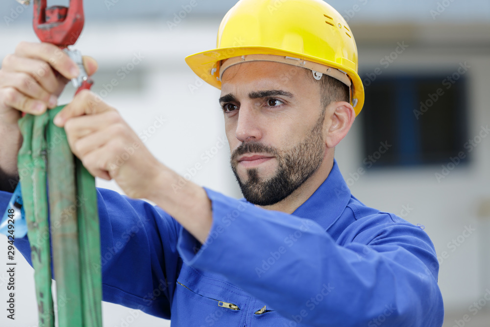 worker holding a hook for work on a container worker holding a hook for work on a container