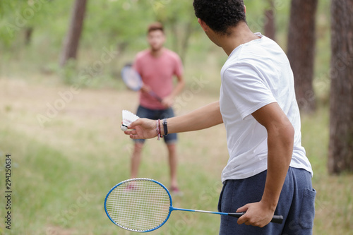 male friends playing recreational badminton © auremar