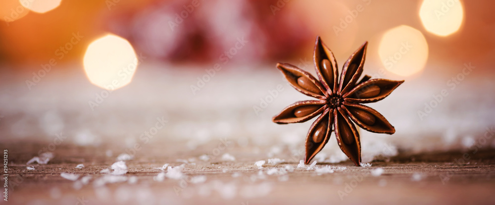 Christmas themed banner or header with a closeup shot of star anise with warm and cozy winter background and copy space - obrazy, fototapety, plakaty 