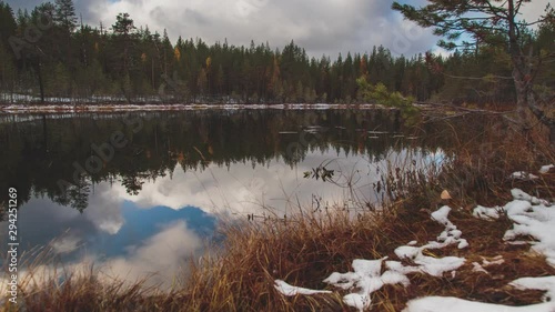 4K Timelapse. Autumn colors and forest lake. Reflection