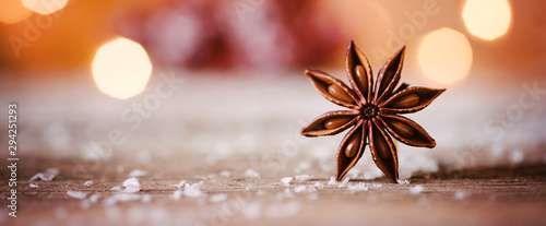 Christmas themed banner or header with a closeup shot of star anise with warm and cozy winter background and copy space