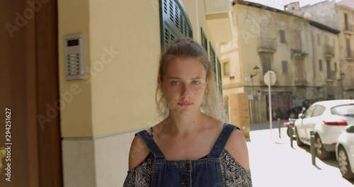 Young Blonde Woman by Spanish Old Town Apartment in Palma City Street.  Travelling Tourist Girl next to a Beautiful HistoricBuilding in Spain... photo