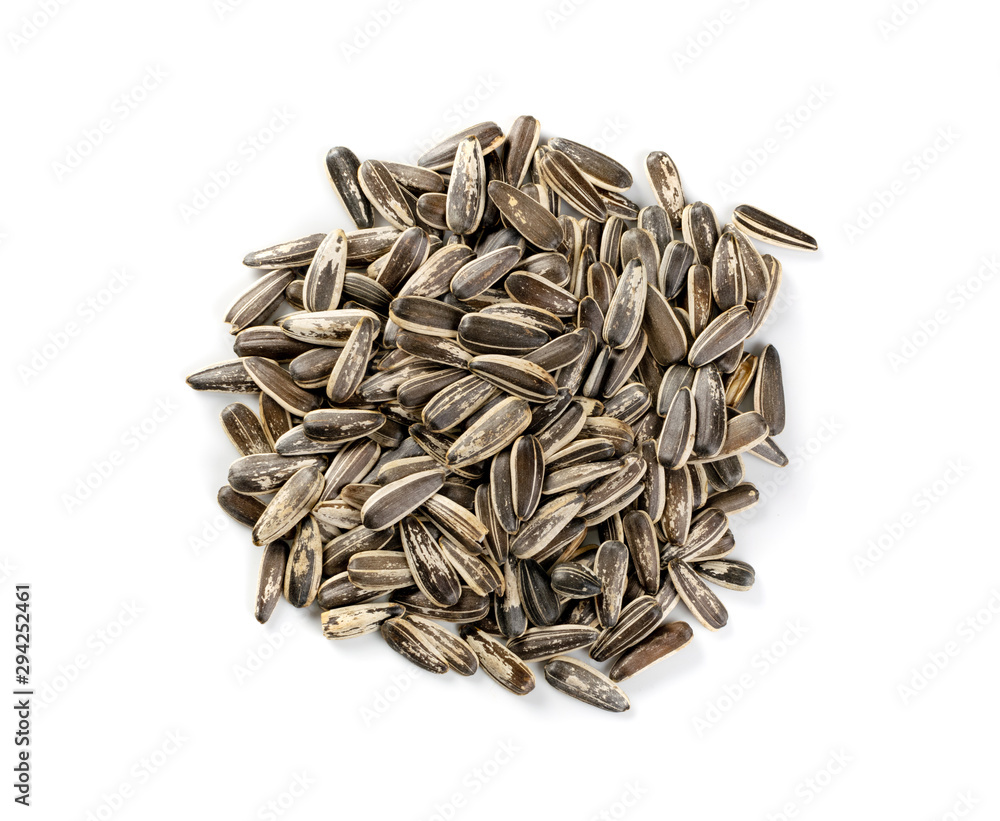 Pile of large striped sunflower seeds with shell isolated Pile of large striped sunflower seeds with shell isolated