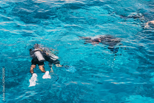 Scuba diving in the tropical sea, diving with masks