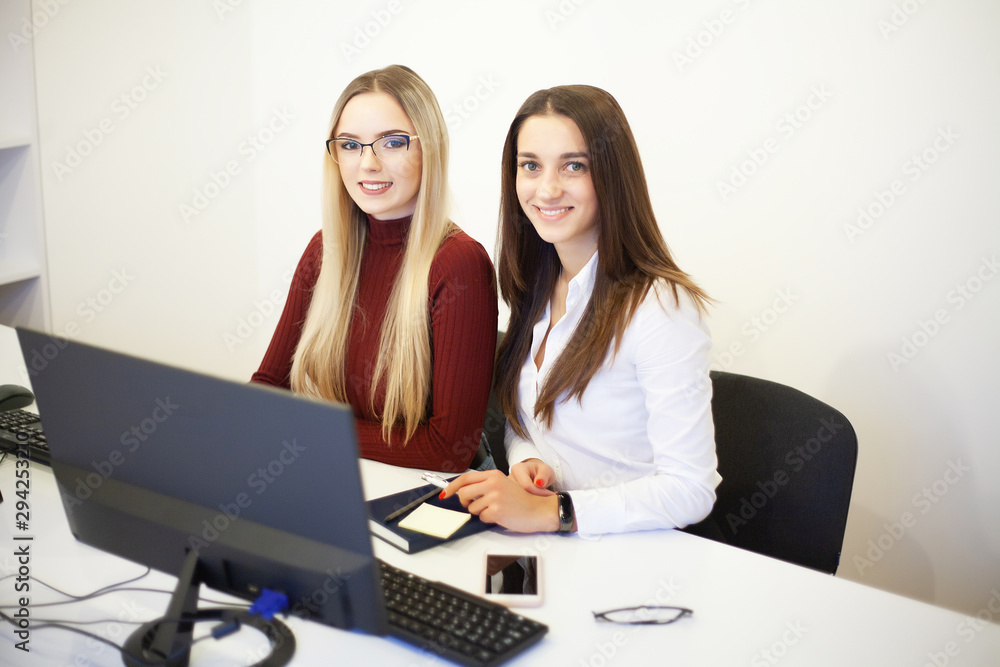 Two beautiful girls work in the office of a consulting company Two beautiful girls work in the office of a consulting company