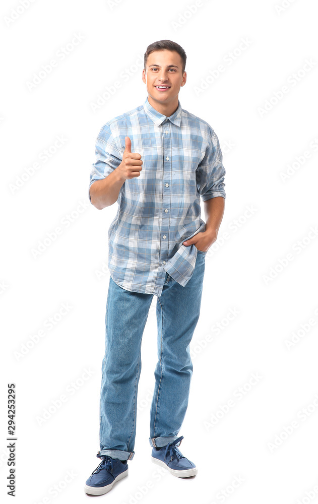 Fototapeta premium Portrait of handsome young man showing thumb-up on white background