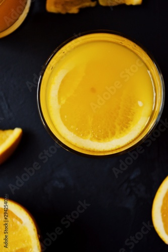 Freshly squeezed orange juice. Orange and orange juice on a dark background. 