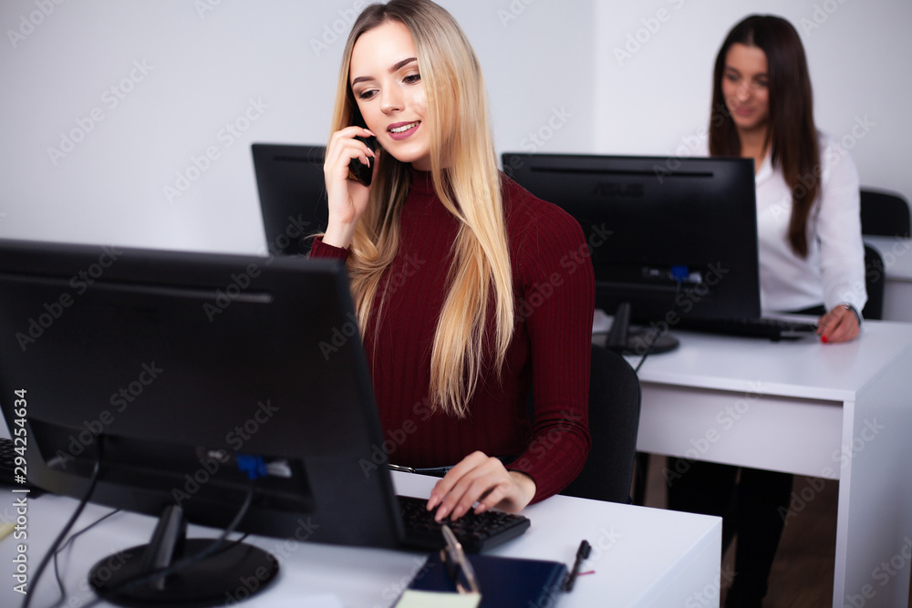 Two beautiful girls work in the office of a consulting company Two beautiful girls work in the office of a consulting company