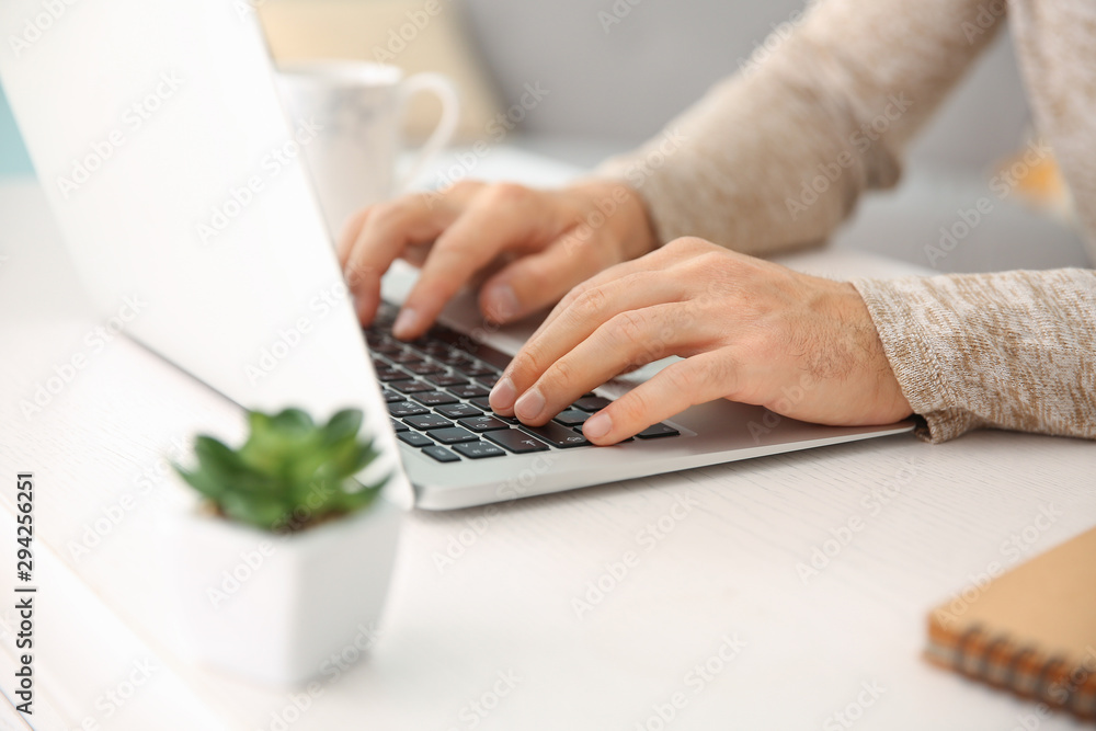 Man working on laptop at home, closeup Man working on laptop at home, closeup