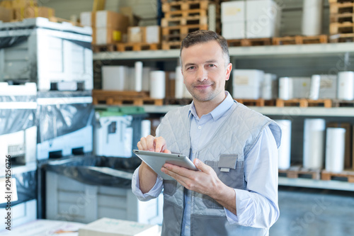 portrait of shipment worker holding tablet