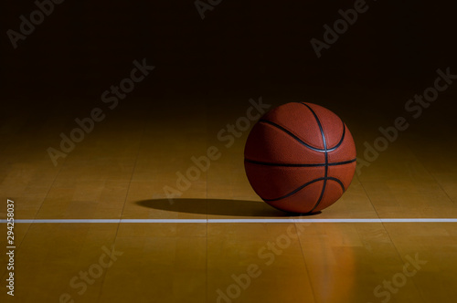 Basketball With Dark Background On A Wood Gym Floor