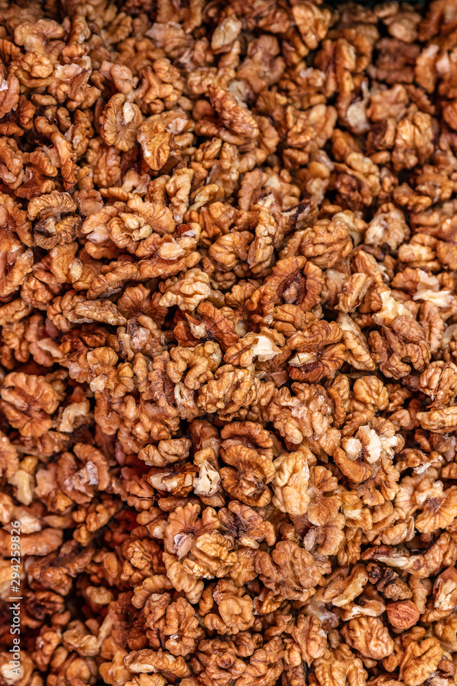 Heap of peeled and chopped walnut without shell for background texture, close-up, top view, copy space for text Heap of peeled and chopped walnut without shell for background texture, close-up, top view, copy space for text