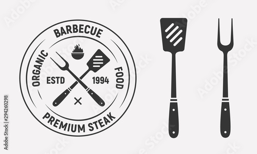 Barbecue vintage logo design with grill fork and spatula isolated on white background. Vector illustration
