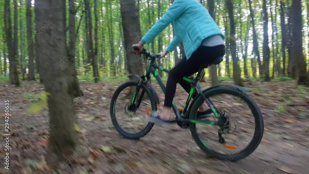 Beautiful young blonde rides a bicycle through the autumn forest. Beautiful young blonde rides a bicycle through the autumn forest.