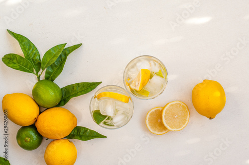 Preparation of refreshing icy lemonade with colorful lemons and lime fruits. Selective focus. photo