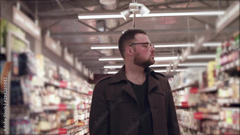 Portrait of the man looks at the market shelves Portrait of the man looks at the market shelves