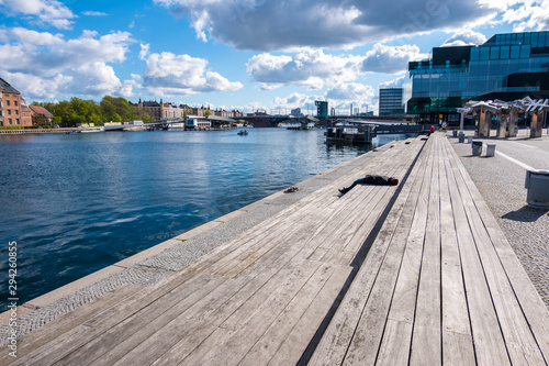 People relax on one of the waterfronts near the BLOX in Copenhagen