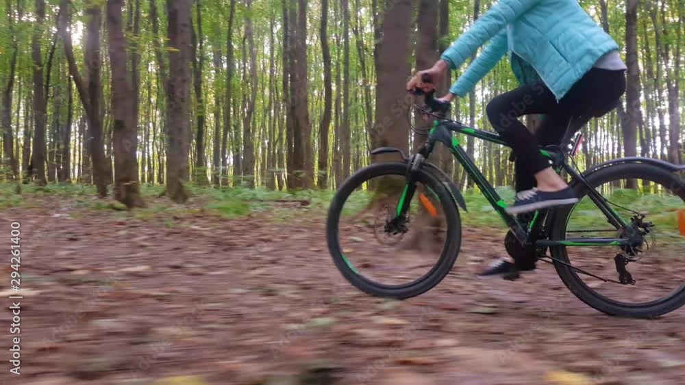 Beautiful young blonde rides a bicycle through the autumn forest. Beautiful young blonde rides a bicycle through the autumn forest.