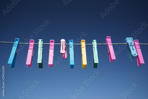 Colorful cloth pegs Blue sky